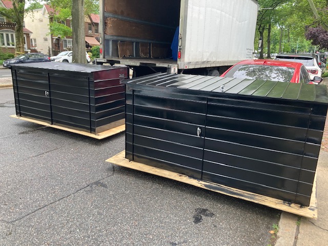 Freshly painted 7-foot Economaster steel garbage enclosures ready for delivery