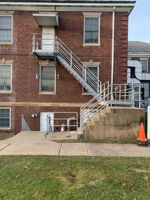 Galvanized metal fire egress staircase with pipe railings