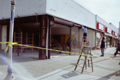 Strip mall new roll down grille gates with steel framing of openings, chain operated type (Queens NY) During photo