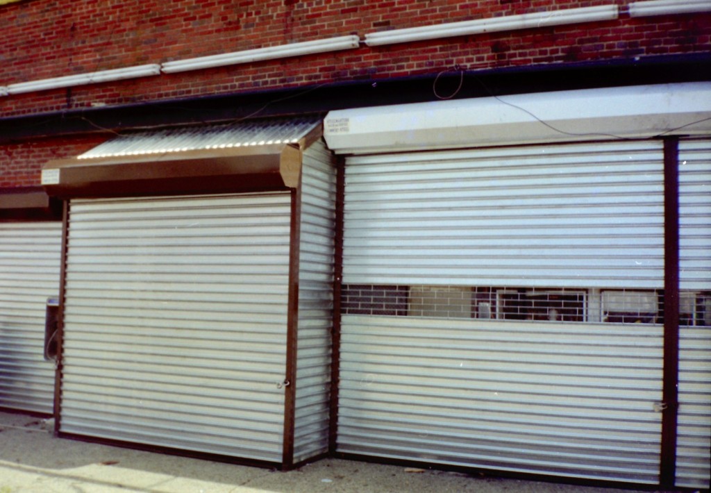 Solid manual roll down security gates with 12’’ grilles insert and