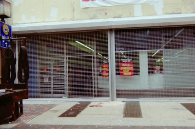 (2) two units 30' long straight link mall type see through grille electric roll down gates. (Philadelphia, PA)