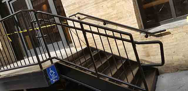 metal steps with picket guardrails and piperail