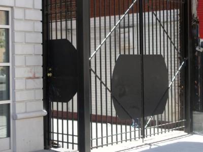 8' tall welded solid square bar fence with structural posts, cross bracing and custom steel plates