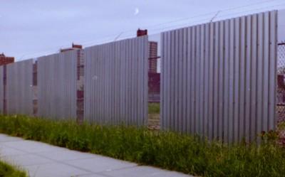 Expanded metal and corrugated steel deck combo 10' fence with barbed wire, Queens