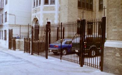 fully welded 8 foot tall solid three quarter square bar fence with cross braces, circles and arrows on top.