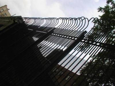 solid steel bar 8′ defender fence. mounted on 3″x ¼” tube steel posts with caps.(brooklyn, ny) 1of 2