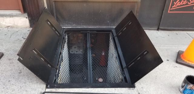 Storefront sidewalk cellar doors, dual-panel with mesh grill, Queens