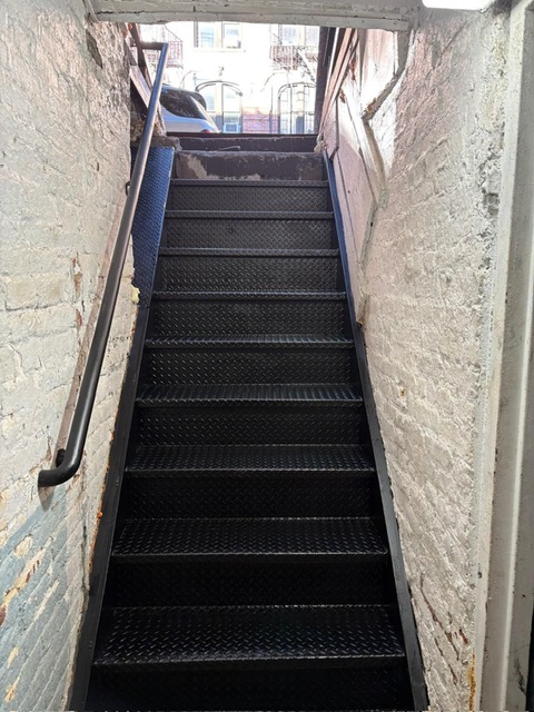 Indoor closed diamond plate restaurant steps, painted black