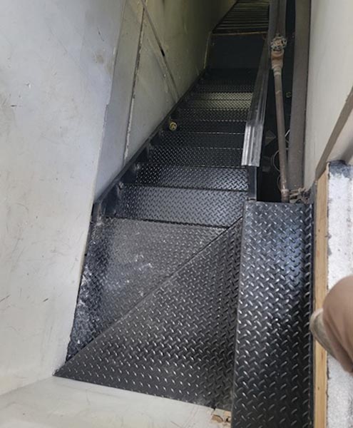 L-shaped indoor rooftop access closed tread staircase with split landing, Astoria
