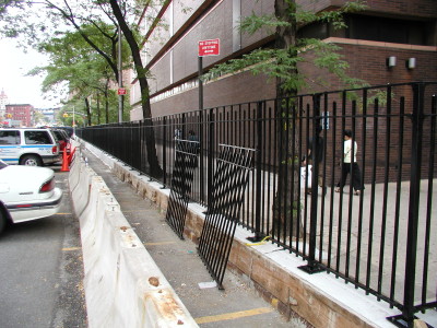 solid steel 4′ fence, curb mounted welded base plates. (ny, ny)