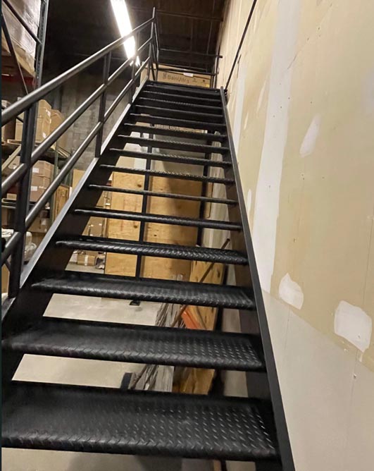 Extra wide open tread diamond plate steel indoor staircase