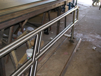 Polished stainless steel pipe railing base plate (Queens, NY)