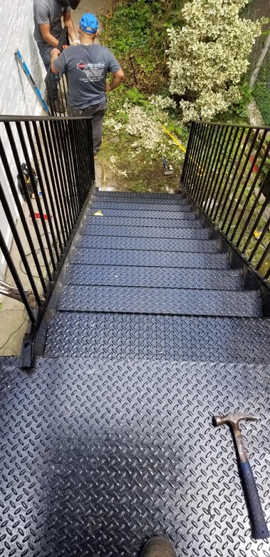outside diamond plate steps with landing and picket railings