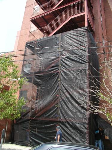 Structural commercial steel pan stair tower structural framing, guardrail stairs landing protective debris mesh
