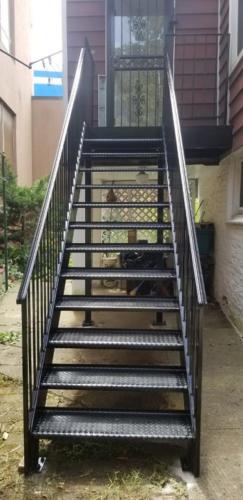 exterior metal stairs with open tread diamond plate fully welded steel steps and solid railings.