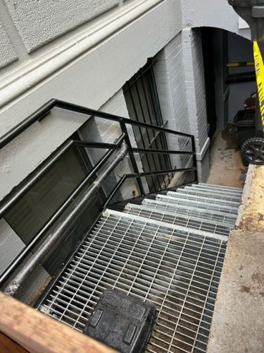 grated steel steps landing tubular railing
