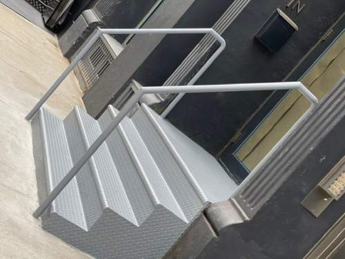 Store entrance metal outdoor closed tread staircases railings