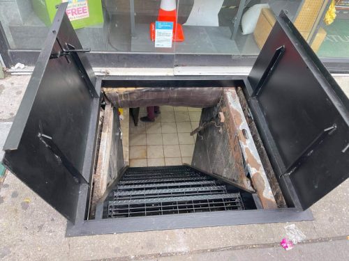 diamond plate steel sidewalk bulkhead double door metal grating staircase wall pipe railing