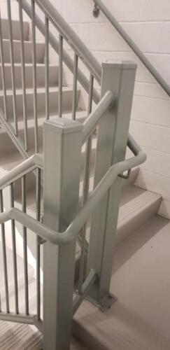 iron railings for fire stairs bolted to concrete slabs