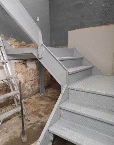Bolt construction welded interior commercial closed tread diamond plate switchback metal staircase, painted upper west side NYC