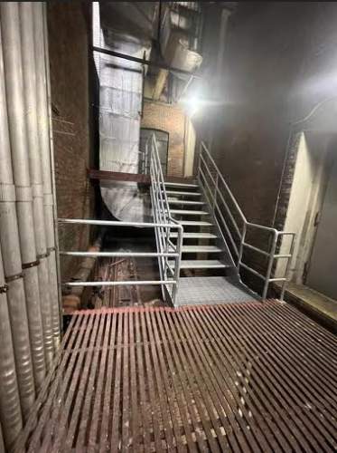 Interior industrial fireproof galvanized metal grating staircases ADA compliant welded pipe railings Midtown Manhattan